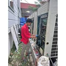 Technician working inside an outdoor HVAC equipment cabinet